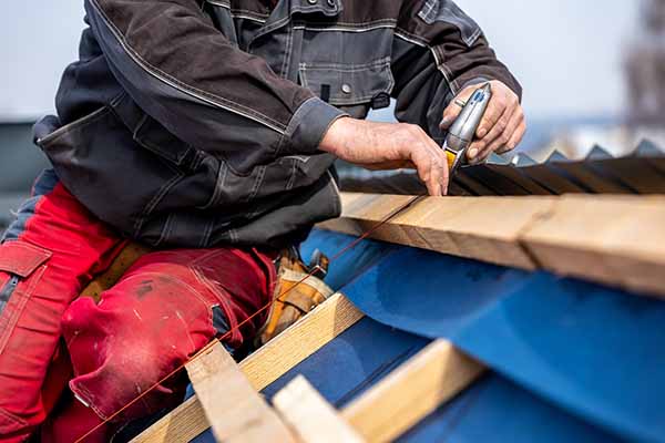 Worker measuring a roof